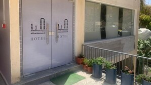 A hotel entrance with double doors labeled "The Castle Star Hotel." - The Castle Star (Amman)