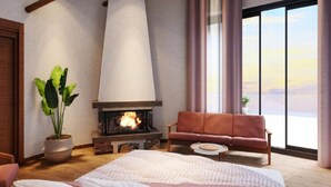 Une pièce avec une cheminée, un canapé, un lit et une grande fenêtre avec des rideaux.