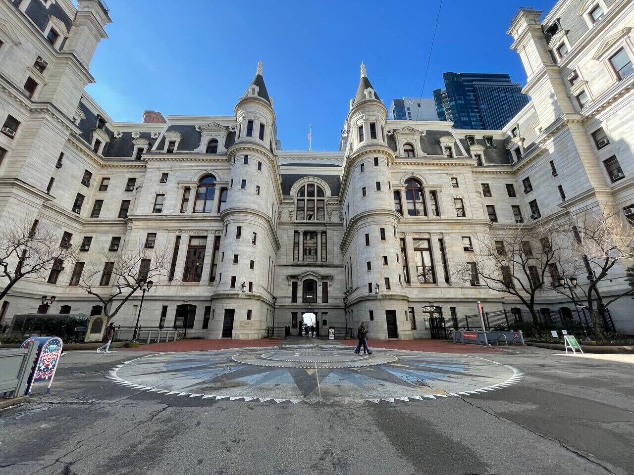 A large, historic building with a symmetrical facade, featuring two prominent towers and a central entrance.