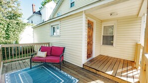 A wooden deck with a red sofa and a patterned rug. - Whispering WillowBnB – Cozy Central Stay Near IUP in Indiana, PA (Indiana)
