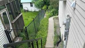 A concrete staircase with black railings leading to a house. - Charming 2-bedroom guest suite in the prime location of Fredericton (Fredericton)
