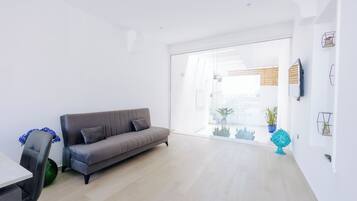 Deluxe Apartment | Living area | 42-inch flat-screen TV with digital channels