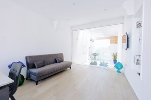 Deluxe Apartment | Living area | 42-inch flat-screen TV with digital channels