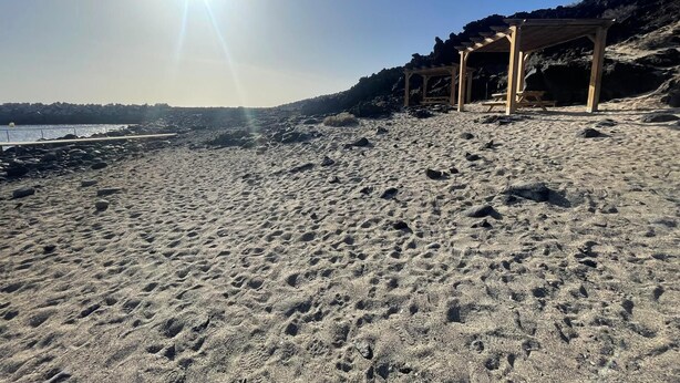 A beach with a wooden gazebo and rocky terrain. - The House of Mercedes (La Restinga)