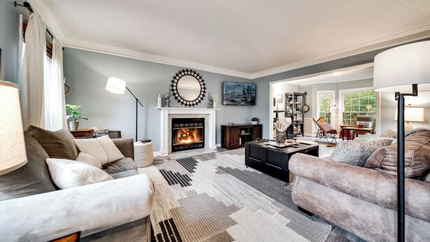 A living room with a fireplace, sofas, a coffee table, and a rug. - Spacious Family Home in Franklin w/ Playground (Franklin)