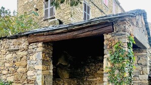 Un bâtiment en pierre doté d’une entrée couverte et d’un escalier menant à l’intérieur.