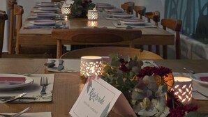 A dining table set with plates, cutlery, and candles, with a 'Reserved' sign on the table. - Hotel TamYanJa (Tamiahua)