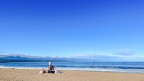 A beach with two fishing rods, a cooler, and a bucket on the sand. - Estrella Residence - Four Bedroom Villa, Sleeps 12 (Plettenberg Bay)