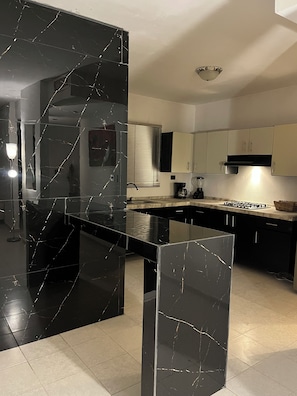 Fridge, microwave, coffee/tea maker, cookware/dishes/utensils