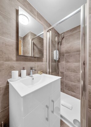 Shower, hair dryer, towels, soap