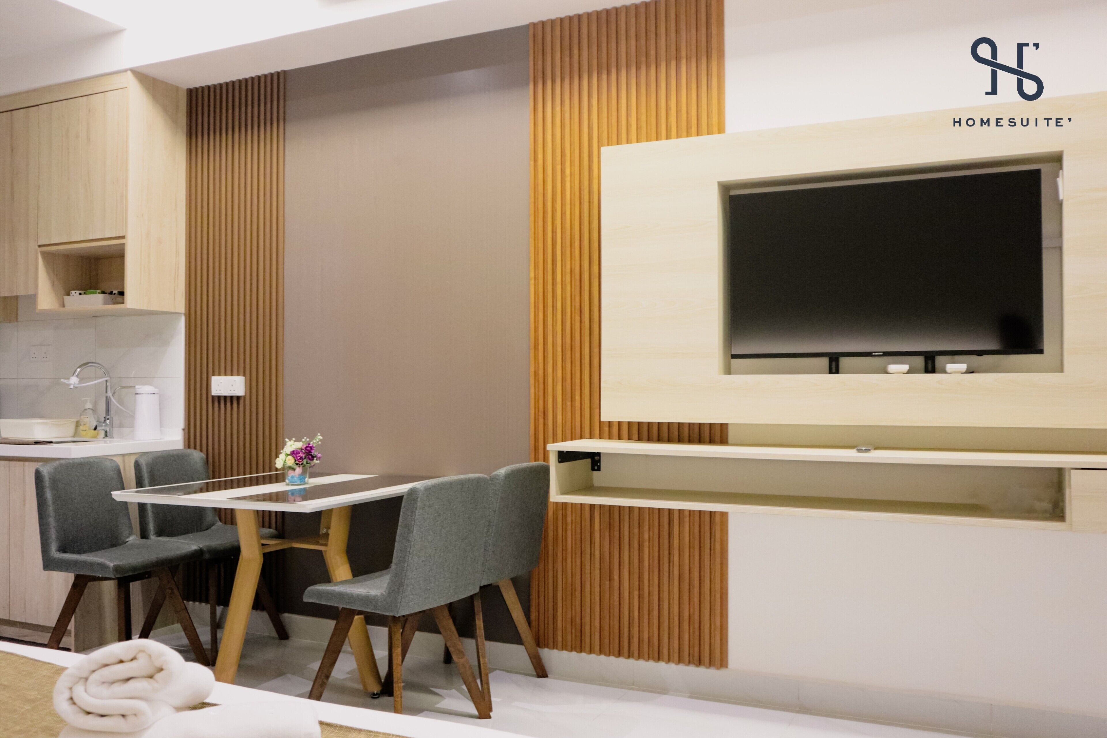 A modern kitchen with wooden cabinets, a built-in oven, and a white countertop.