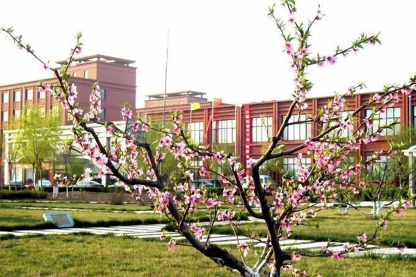 A building with a modern architectural style, featuring a red facade and large windows. - Taoyuan Hotel (Pingyuan)