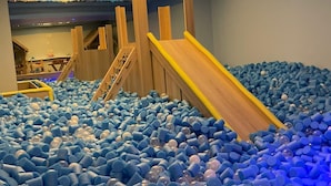 A play area with a ball pit and a wooden slide. - Pousada dos Anjos (Canela)