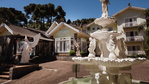 A building with a sign reading "Pousada dos Anjos" and a fountain with angel statues. - Pousada dos Anjos (Canela)