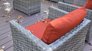 An outdoor wicker furniture set with red cushions on a wooden deck. - 1 Mile From Ski Slope and Festivals - 125 Nightly Fee (Hunter)