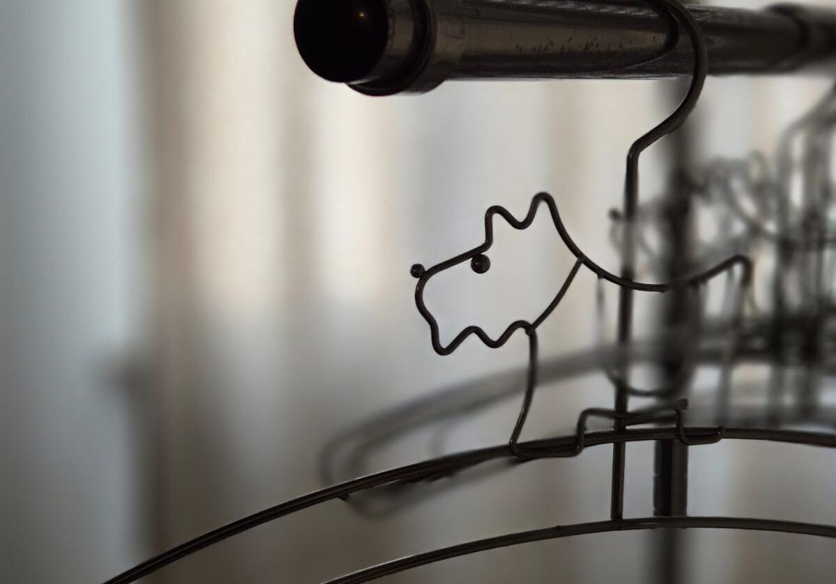 A metal structure with a wireframe design, possibly part of a larger installation or architectural feature.