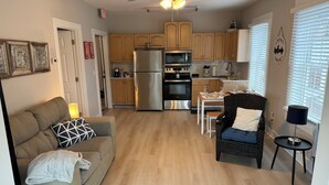 A compact living space with a kitchenette, a dining area, and a seating area. - 1 BR Apt - Walk to Historic Hub (St. Augustine)