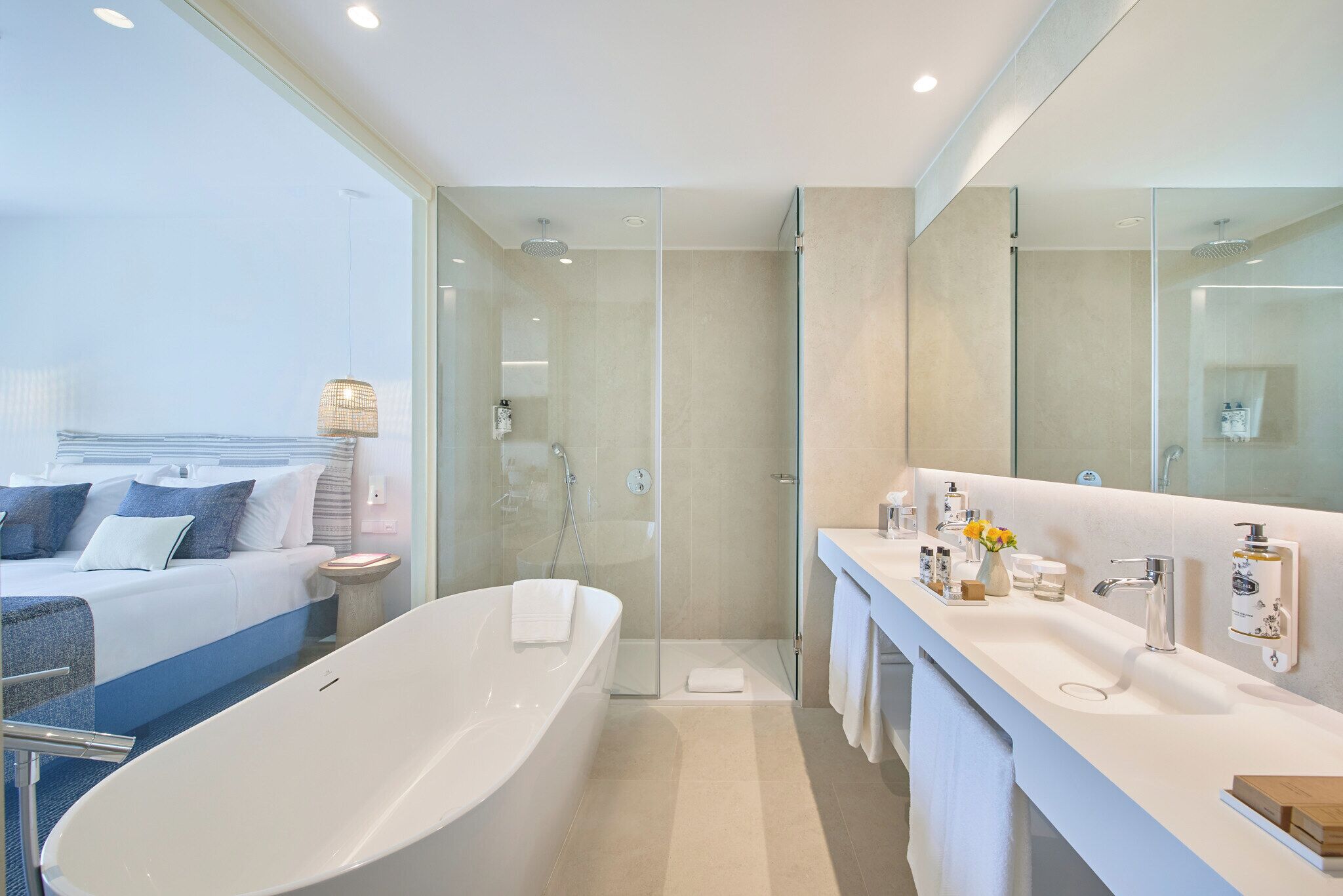 A modern bathroom with a freestanding bathtub, a large mirror, and a shower area.