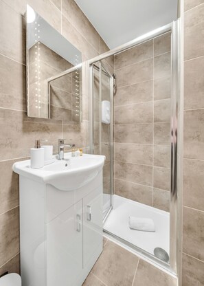 Shower, hair dryer, towels, soap