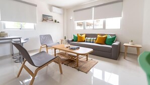 A modern living room with a sofa, chairs, a coffee table, and a small side table. - Landa Mar Boca Chica (Boca Chica)
