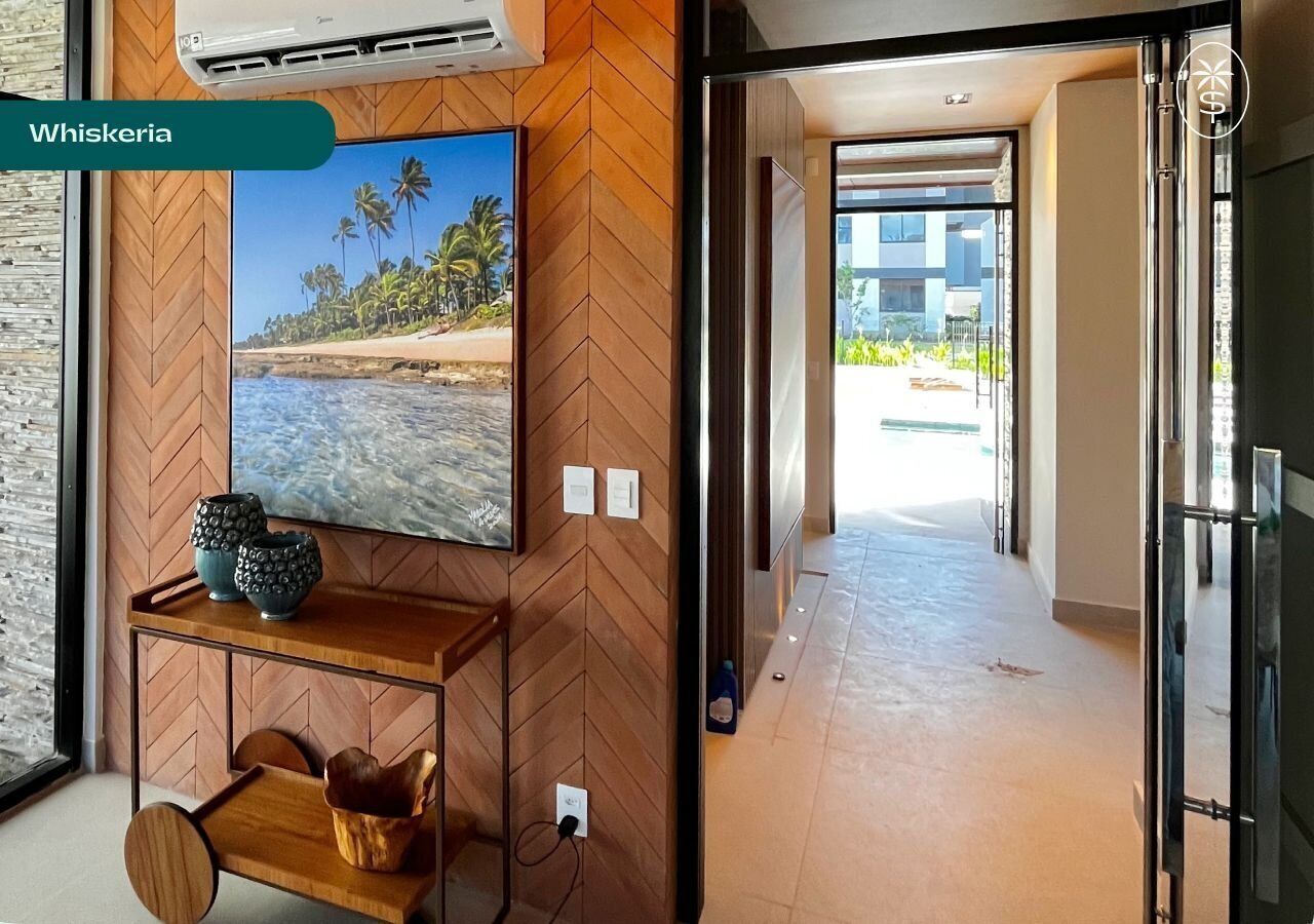A modern hallway with a wooden herringbone floor, a wall-mounted air conditioning unit, and a view of a beach through a large window.