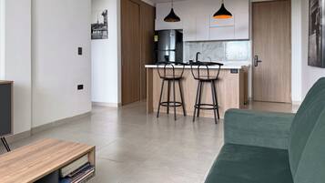 Deluxe Apartment, Balcony, Hill View | Living area | Flat-screen TV