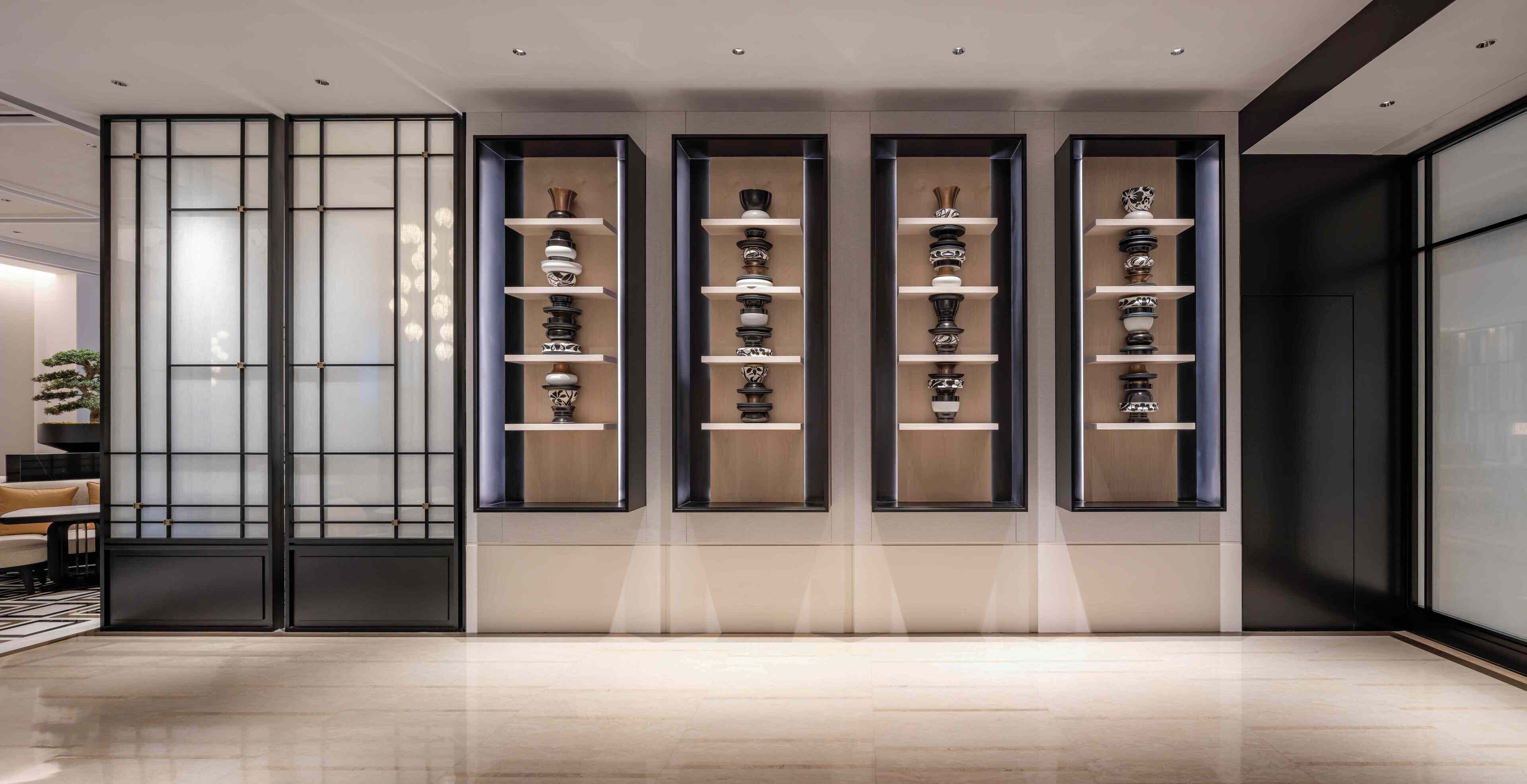 A modern interior with a series of display shelves showcasing various decorative items.