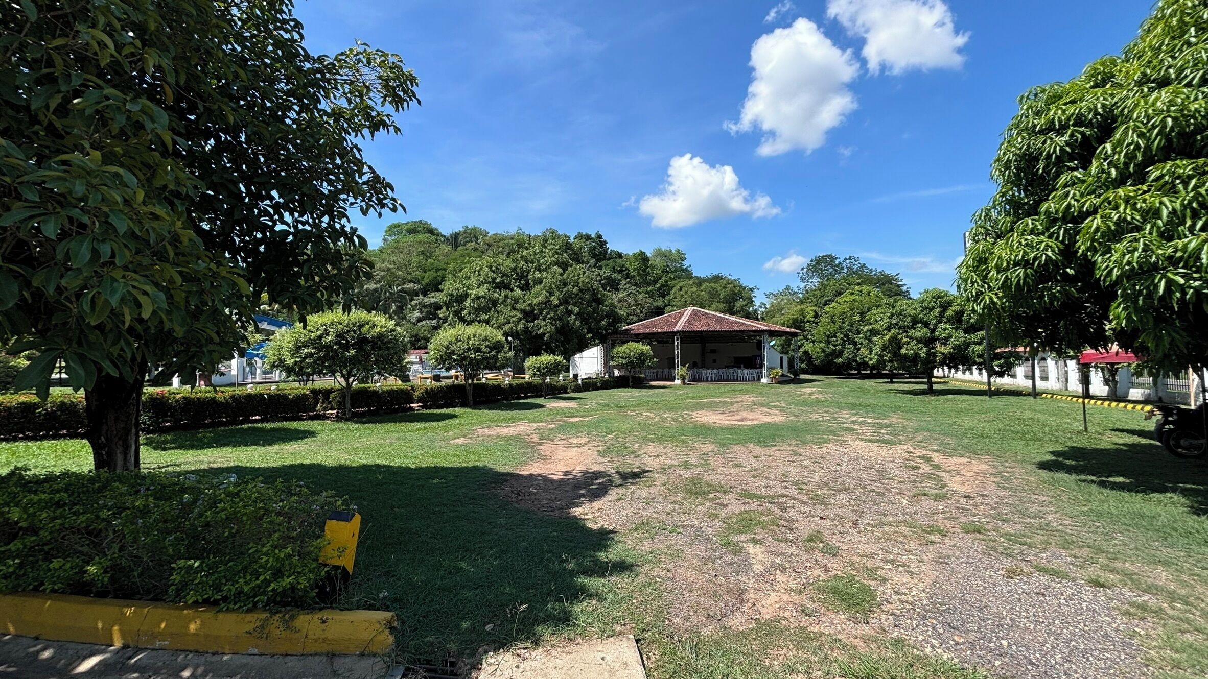 A park with a gazebo, trees, and a grassy area.