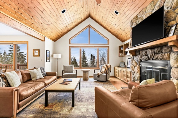 Bright and cozy upstairs living room with large windows framing Lake Superior views. Perfect for relaxing, gathering and sharing stories of your adventures exploring Minnesota's North Shore.
