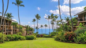 A hotel with multiple floors, balconies, and a view of the ocean. - Kona Makai #5203 Ocean View , 
A Hawaiian Paradise (Kailua-Kona)