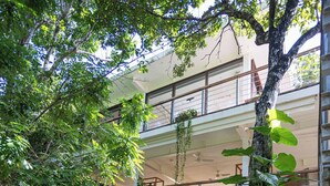 A modern building with a rooftop garden, a swimming pool, and a staircase leading to the upper levels. - A Peaceful, Tropical Loft in the heart of the Riviera Maya (TLM Akumal)
