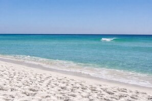 A beach with clear turquoise water and white sand.