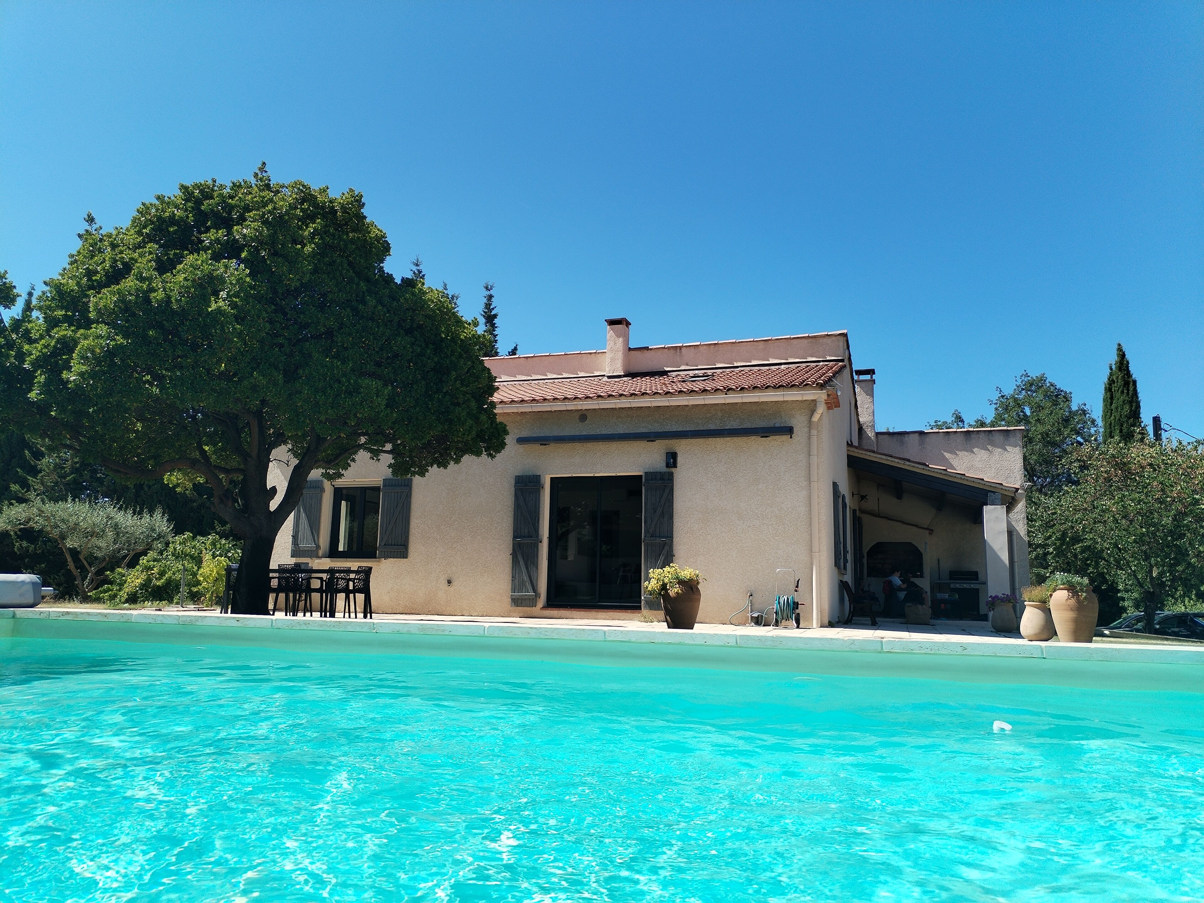 A building with a swimming pool in front.