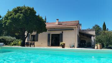 A building with a swimming pool in front.