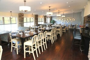 A restaurant with long tables, chairs, and hanging lights. - Blue Ridge | Lakeside Glamping Stay | Trails & Family Fun (Gordonsville)