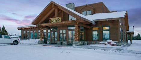 A log cabin-style building with a sign reading "Yellowstone MAX".