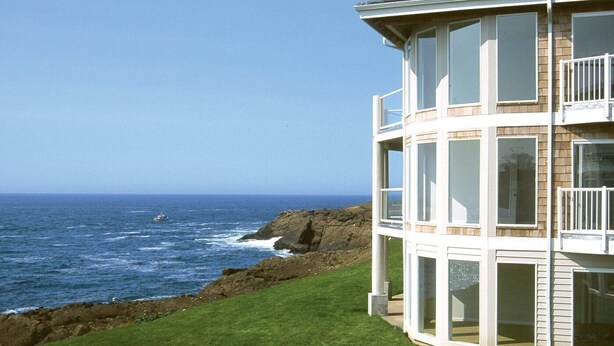 A coastal building with multiple balconies overlooking the ocean.