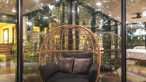 A room with a large window, a hanging chair, and a bed. - Mo-ööd House Glamping/ Floating (Licking)