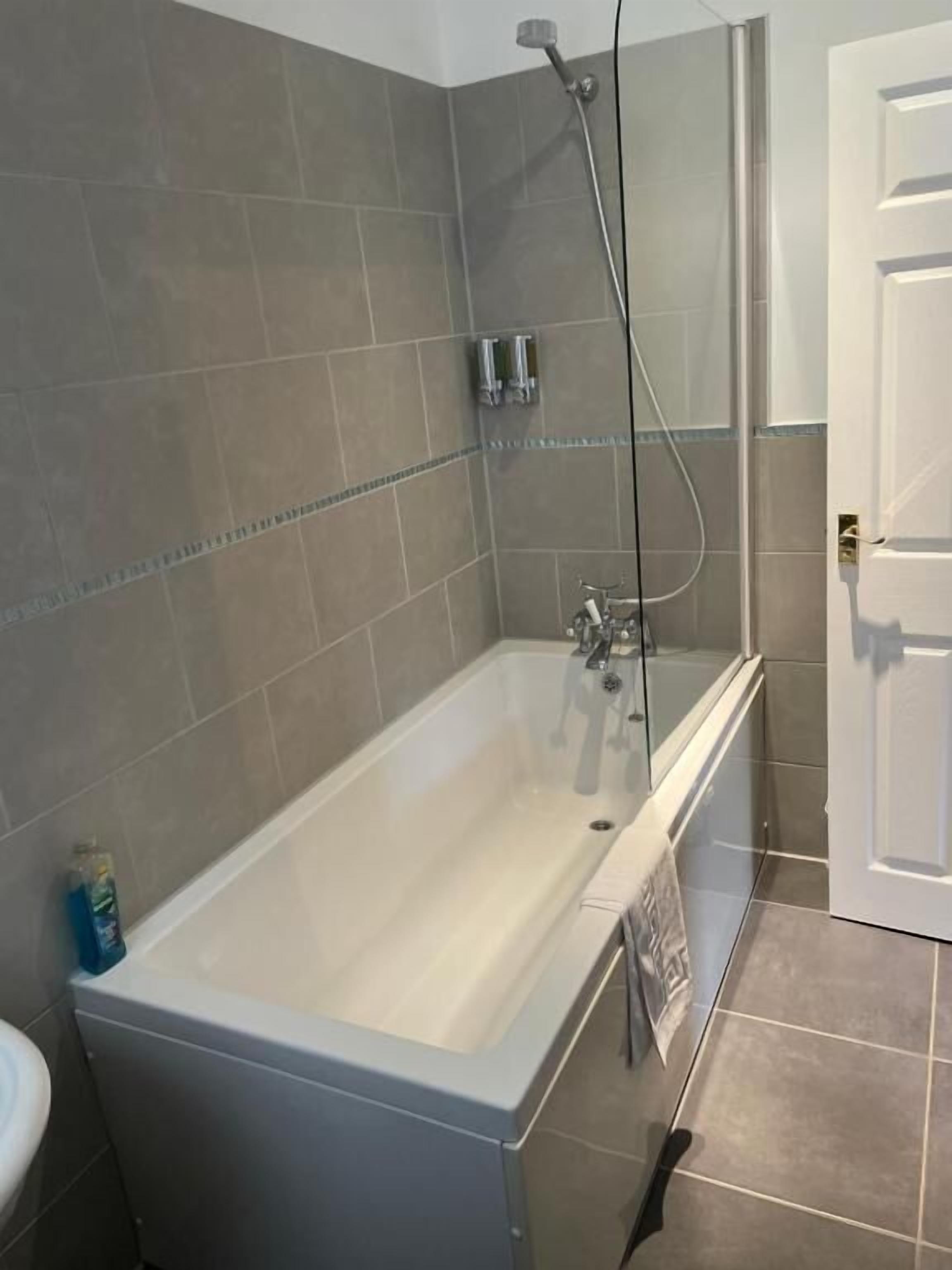 A bathroom with a bathtub, a shower, and a toilet.