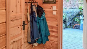 A wooden interior with a wooden door leading to an outdoor area. - Beach front home in Omastrand (Omastrand)