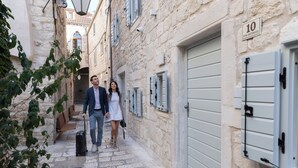 A narrow stone-paved alley with a building featuring a number '10' sign, suggesting a hotel or guesthouse. - Forkira Luxury Hvar (Hvar)