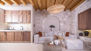 A modern kitchen with wooden cabinets and a stone wall. - Forkira Luxury Hvar (Hvar)