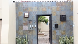 A gated entrance with a stone wall, a sign reading "No 13 CBA", and a small signboard with "Son Angel". - Modern 3-bedroom Retreat in Ajijic-walk To Everything-gym-pickleball-golf Cart (Chapala)
