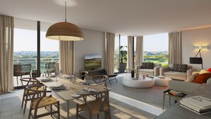 A modern living room with a dining area, large windows with a view, and a flat-screen TV.