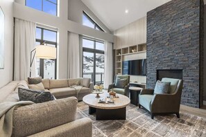 A modern living room with a sofa, armchairs, a coffee table, and a fireplace. - Abode at Deer Valley East, hot tub, pool, resort access, Deer Valley (Park City)