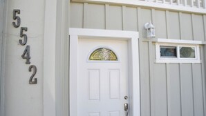 A white door with a glass panel and a small window above it.