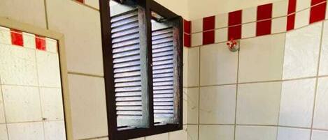 Un baño con lavamanos, inodoro y ventana.