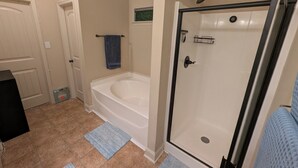 A bathroom with a bathtub, a shower, and a toilet. - Masters Rental - Walking Distance + WFH Spaces! (Augusta)