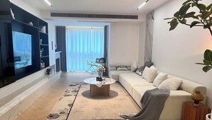 A modern living room with a sofa, coffee table, and a TV. - Eastern Hub - Superior 3bedroom Near TianZiFang&XinTianDi, Near Subway (shanghai)