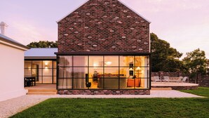 A modern house with a brick exterior and large glass windows. - Leighton House, an unforgettable luxury farm stay in Northern Tasmania, Evandale (Western Junction)